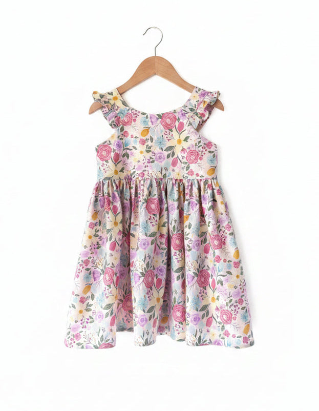 Floral dress on a wooden hanger against a plain background