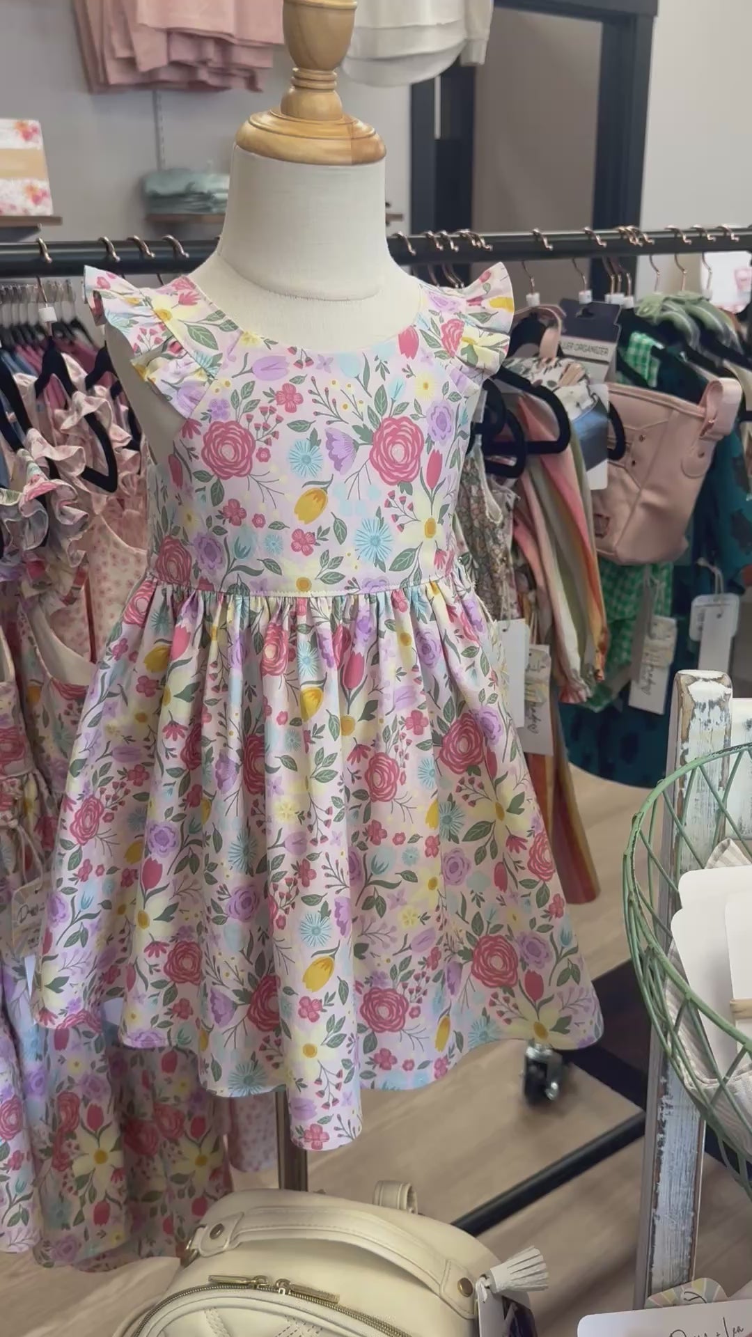 Floral dress on a mannequin in a store.